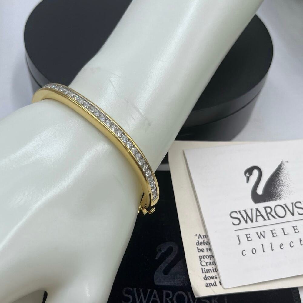 SWAROVSKI Vintage Swan Signed
Blinding Ice Crystal Hinged‎ Bangle Gold Tone